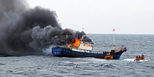 In this Thursday, Sept. 29, 2016 photo provided by the South Korean Mokpo Coast Guard, a Chinese fishing boat catches fires during an inspection by the South Korean coast guard in the water off Hong Island, South Korea. South Korea’s coast guard said three Chinese fishermen have been found dead when a fire broke out on their boat after the coast guard fired a flashbang grenade at the vessel to stop it. (South Korean Mokpo Coast Guard via AP)