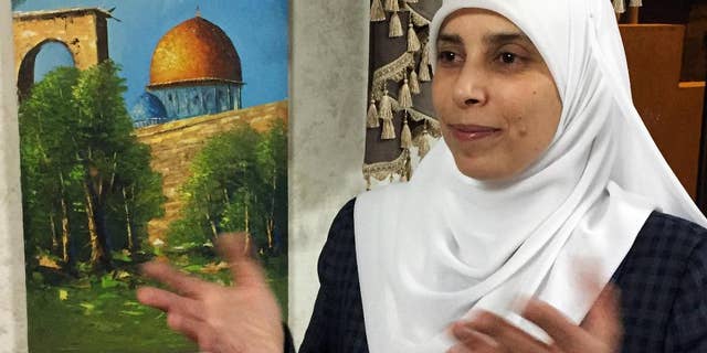 In this photo taken Tuesday, March 21, 2017, Ahlam al-Tamimi is photographed during an interview in her home in the Jordanian capital of Amman. The 37-year-old who guided the bomber to his target said she fears for her life after getting death threats and defends her role in killing civilians as legitimate resistance to Israeli occupation. (AP Photo/Omar Akour)