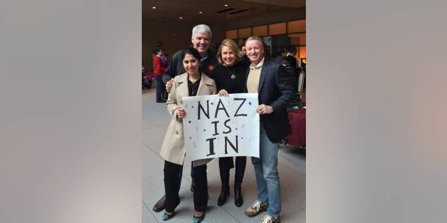 In this photo provided by Eric Martinez, Nazanin Zinouri, front left, and her colleagues from Modjoul, a startup technology firm in Clemson, S.C., pose for a photo after Zinouri arrived at Logan International Airport in Boston on Sunday, Feb. 5, 2017. Zinouri, an Iranian engineer who had been blocked from returning to South Carolina by President Donald Trump's travel ban against seven Muslim nations, returned to the U.S. on Sunday. Modjoul founder Martinez, from left, co-worker Jen Thorson and Rick Toller stand by Zinouri. (courtesy of Eric Martinez via AP)