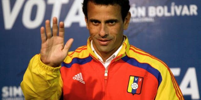 April 13, 2013: Opposition presidential candidate Henrique Capriles waves as he arrives to a news conference in Caracas, Venezuela.