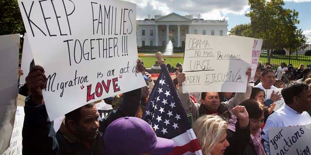 In this Nov. 7, 2014 file photo, people rally for comprehensive immigration reform outside the White House in Washington.