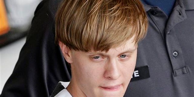 Charleston, S.C., shooting suspect Dylann Roof is escorted from the Cleveland County Courthouse in Shelby, N.C., Thursday, June 18, 2015. (AP Photo/Chuck Burton)