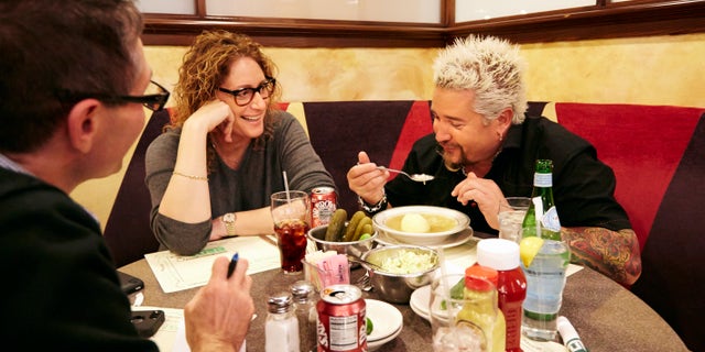 Dec. 9, 2013: Food Network star Guy Fieri, right, tasting matzo ball soup at Ben's Deli as comedian Judy Gold, center, and AP Food Editor J.M Hirsch look on.