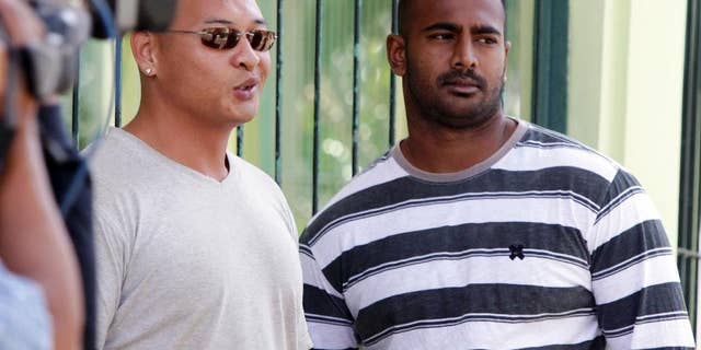 FILE - In this Aug. 17, 2011 file photo, Australian death-row prisoners Myuran Sukumaran, right and Andrew Chan, left, stand in front of their cell during an Indonesian Independence Day celebration at Kerobokan prison in Bali, Indonesia. Australia's Foreign Minister Julie Bishop on Thursday, Feb. 12, 2015 called on the Indonesian government to show the same mercy to two Australian drug traffickers on death row as Indonesia seeks from countries where Indonesian citizens face execution. (AP Photo/Firdia Lisnawati, File)