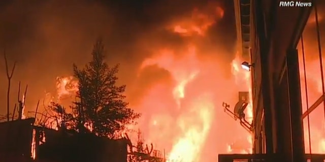 Residents helped evacuated an apartment building in North Hollywood, Calif. early Wednesday after a raging fire broke out.