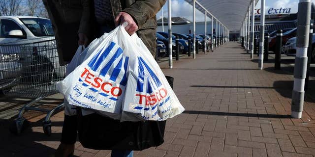 Tesco said Wednesday it has agreed to form a joint venture with China Resources Enterprise, but added interim net profits dived amid "challenging" trade in Europe