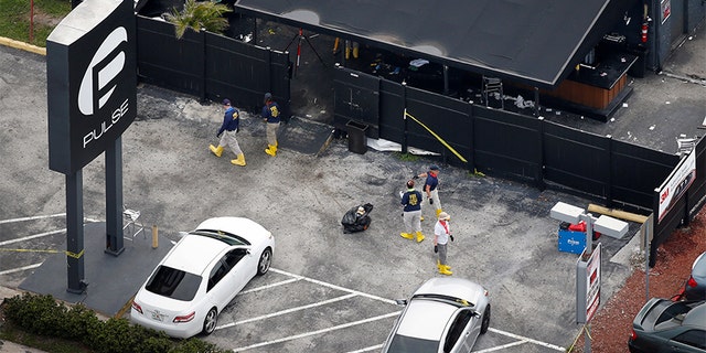 June 15, 2016: Federal Bureau of Investigation officials collect evidence from the parking lot of the Pulse nightclub in the days after the attack.