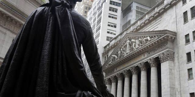 FILE - In this Oct. 2, 2014, file photo, the statue of George Washington on the steps of Federal Hall faces the facade of the New York Stock Exchange. U.S. stocks rose broadly in the first half-hour of trading Tuesday, Feb. 3, 2015, on higher oil prices and signs that the new Greek government won't press for a write-off of its bailout loans. European stocks were sharply higher, too. (AP Photo/Richard Drew, File)