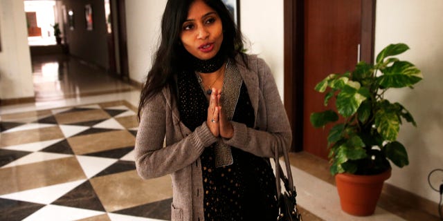 Devyani Khobragade, who served as India’s deputy consul general in New York, greets journalists as she leaves Maharastra state house in New Delhi, India, Saturday, Jan. 11, 2014. Khobragade, 39, is accused of exploiting her Indian-born housekeeper and nanny, allegedly having her work more than 100 hours a week for low pay and lying about it on a visa form. Khobragade has maintained her innocence, and Indian officials have described her treatment as barbaric. (AP Photo/Saurabh Das)