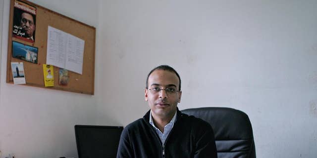FILE -- This Dec. 7, 2011 photo, shows Hossam Bahgat in his office at the Egyptian Initiative for Personal Rights in Garden City, Cairo, Egypt.  An Egyptian court on Saturday, Sept. 17, 2016 upheld a decision to freeze the assets of several prominent human rights campaigners in the latest blow to a once-vibrant activist community that has been largely silenced by a government crackdown. The five activists named in the court ruling include Gamal Eid and Bahey eldin Hassan, who head two well-known human rights organizations, as well as investigative reporter Hossam Bahgat, also the founder of a rights group. The other two are Mustafa el-Hassan and Abdel-Hafiz Tayel.  (Sarah Rafea via AP, File) MANDATORY CREDIT