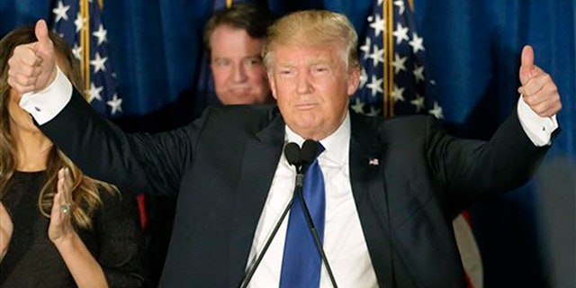 Republican presidential candidate, businessman Donald Trump gives thumbs up to supporters during a primary night rally, Tuesday, Feb. 9, 2016, in Manchester, N.H. (AP Photo/David Goldman)