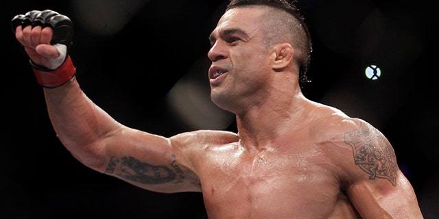 FILE - In this Jan. 20, 2013 file photo, Vitor Belfort, from Brazil, celebrates after defeating Michael Bisping during a middleweight mixed martial arts bout in Sao Paulo, Brazil. Belfort is scheduled to fight Chris Weidman in a middleweight title matchup on Saturday, May 23, 2015 at UFC 187. in Las Vegas,.(AP Photo/Andre Penner, File)