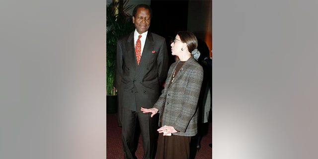 Actor Sidney Poitier (L) chats with Supreme Court Justice Ruth Bader Ginsburg before the premiere of the film, "Mandela and de-Klerk," in which Poitier plays the role of Nelson Mandela, 1997.