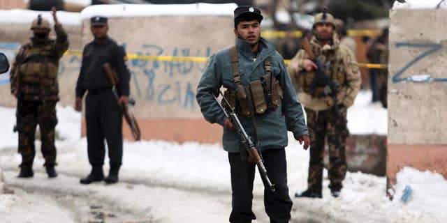 Security personnel stand guard at the site of a suicide attack on the Supreme Court in Kabul, Afghanistan, Tuesday, Feb. 7, 2017. A suicide bomber on Tuesday targeted the Supreme Court building in the Afghan capital, Kabul, killing over a dozen people, officials said. (AP Photo/Rahmat Gul)