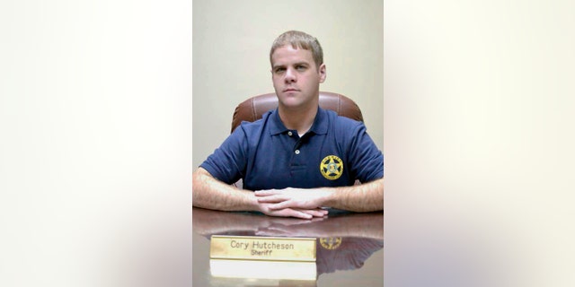 FILE - In this undated file photo, Mississippi County Sheriff Cory Hutcheson sits behind his desk at the Mississippi County Detention Center in Charleston, Mo. Hutcheson, a Missouri sheriff who continued to work despite having his sheriff's license suspended after his arrest last month on assault and other charges, was involved in a jail altercation last week in which an inmate died, Missouri's top prosecutor said in calling for his firing on Tuesday, May 9, 2017. (Leonna Heuring/Sikeston Standard Democrat via AP, File)