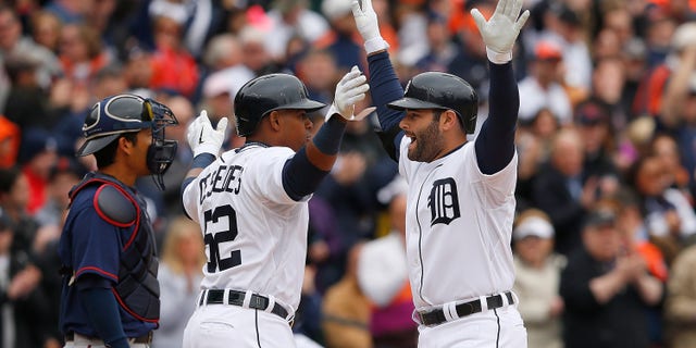 DETROIT, MI - APRIL 6: Alex Avila #13 of the Detroit Tigers celebrates with teammate Yoenis Cespedes #52 after hitting a two run home run in the second inning of the the Opening Day game against the Minnesota Twins at Comerica Park on April 6, 2015 in Detroit, Michigan. (Photo by Leon Halip/Getty Images)