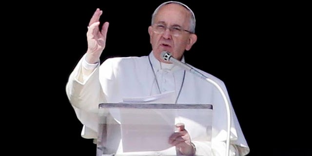 Pope Francis delivers his blessing during the Angelus noon prayer from a window of the Apostolic palace in St. Peter's Square, at the Vatican, Sunday, Feb. 8, 2015. (AP Photo/Gregorio Borgia)