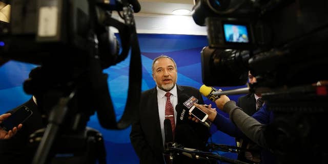 FILE - In this Dec. 28, 2014 file photo, Israel's Minister of Foreign Affairs Avigdor Lieberman, speaks to the media ahead of the weekly cabinet meeting in Jerusalem. A corruption investigation that has roped in 30 Israeli public figures and politicians linked to the Lieberman's Yisrael Beitenu party has shaken up the campaign ahead of March elections, throwing the hard-line party's future into disarray. (AP Photo/Gali Tibbon, File)