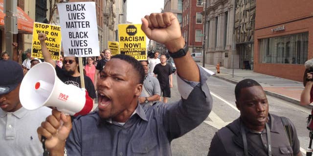 FILE - In a Wednesday, Sept. 2, 2015 file photo, Pastor Westley West, from Faith Empowered Ministries, leads protesters as they march towards Pratt Street and the Inner Harbor, in Baltimore, as the first court hearing was set to begin for six police officers criminally charged in the death of Freddie Gray. West was arrested Wednesday, Sept. 9, a week after police say he blocked traffic while protesting during pre-trial hearings in the Freddie Gray case. He is charged with attempting to incite a riot, malicious destruction of property, disorderly conduct, disturbance of the peace, false imprisonment and failure to obey. (Lloyd Fox/The Baltimore Sun via AP, File) WASHINGTON EXAMINER OUT; MANDATORY CREDIT