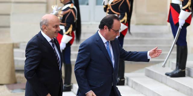 France's President Francois Hollande, right, welcomes Prime Minister of Kosovo Isa Mustafa, prior to the Balkans summit, at the Elysee Palace, in Paris, Monday, July 4, 2016. The leaders of France, Germany, Italy and Balkan nations are meeting to better prevent extremists from sneaking in with migrants who are moving west across Europe. (AP Photo/Thibault Camus)