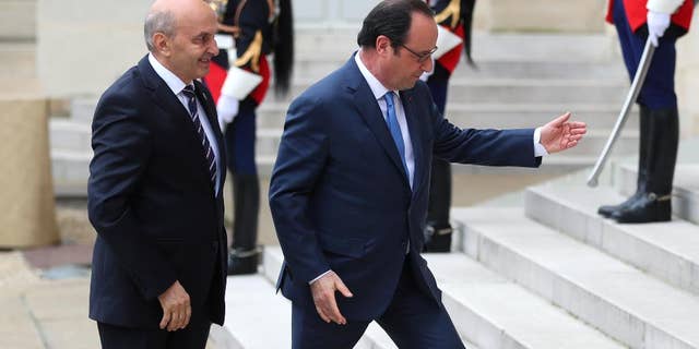France's President Francois Hollande, right, welcomes Prime Minister of Kosovo Isa Mustafa, prior to the Balkans summit, at the Elysee Palace, in Paris, Monday, July 4, 2016. The leaders of France, Germany, Italy and Balkan nations are meeting to better prevent extremists from sneaking in with migrants who are moving west across Europe. (AP Photo/Thibault Camus)