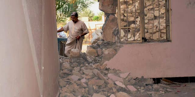 A man inspects his house damaged after a bomb attack by Islamic State group extremists in Khalidiya, 60 miles (100 kilometers) west of Baghdad, Iraq, Sunday, Sept. 20, 2015. (AP Photo)