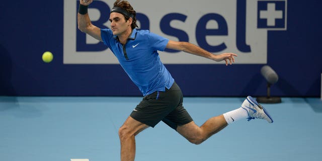 FILE - This is a  Sunday, Oct. 28, 2012  file photo of Switzerland's Roger Federer as he returns a ball to Argentina's Juan Martin Del Potro during their final match at the Swiss Indoors tennis tournament at the St. Jakobshalle in Basel, Switzerland. Roger Federer says  he will play at the Swiss Indoors in October, ending speculation he could skip his hometown tournament in a contractual dispute. Federer told the  Swiss daily Tages Anzeiger on Wednesday April 10, 2013 that "everyone knows how much this tournament means to me, and that is still true."  (AP Photo/Keystone/Georgios Kefalas, File)