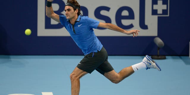 FILE - This is a Sunday, Oct. 28, 2012 file photo of Switzerland's Roger Federer as he returns a ball to Argentina's Juan Martin Del Potro during their final match at the Swiss Indoors tennis tournament at the St. Jakobshalle in Basel, Switzerland. Roger Federer says he will play at the Swiss Indoors in October, ending speculation he could skip his hometown tournament in a contractual dispute. Federer told the Swiss daily Tages Anzeiger on Wednesday April 10, 2013 that "everyone knows how much this tournament means to me, and that is still true." (AP Photo/Keystone/Georgios Kefalas, File)