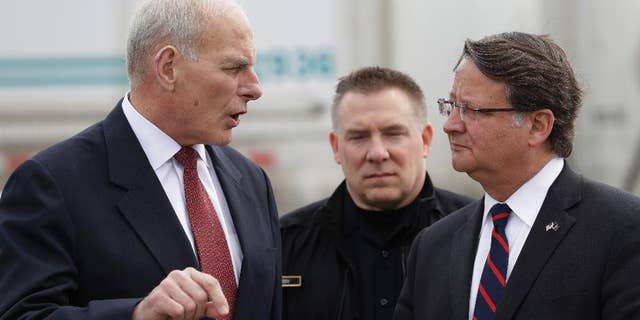 Former Homeland Security Secretary John Kelly, left, talks with Sen. Gary Peters D-Mich., before a news conference at the Ambassador Bridge border crossing, Monday, March 27, 2017, in Detroit. Kelly observed northern border operations and met with DHS personnel, local immigration stakeholders and Arab American community members. (AP Photo/Carlos Osorio)