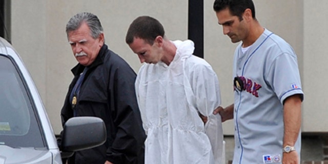 June 22: David Laffer, a suspect in the shooting deaths of four people at a pharmacy during a botched weekend painkiller robbery, is escorted out of Suffolk County Police Headquarters in Yaphank, N.Y.