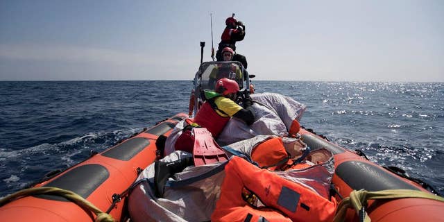 Proactiva Open Arms crew conduct a search and rescue operation in the Mediterranean sea, 12 nautic miles from the Libyan coast, Thursday, April 13, 2017. The Libyan coast guard says 97 migrants are missing and believed drowned after their Europe-bound boat sank on a perilous crossing of the Mediterranean Sea. (AP Photo/Bernat Armangue)