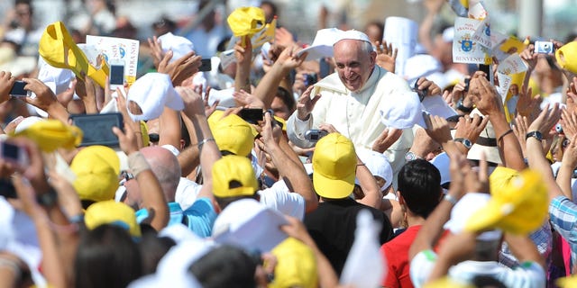 Lampedusa, Italy-July 8: Pope Francisco waved to his followers when he arrived on Lampedusa, Italy on July 8, 2013. On his first official trip outside Rome, Pope Francis arrives at Lampedusa Island Airport, mourning the people who died at the crossroads, boarding a boat with a fisherman on his boat and garlands in the sea. Dedicated. The Pope also met with a group of immigrants at the pier and celebrated the Mass.  (Photo by Tullio M. Puglia / Getty Images)