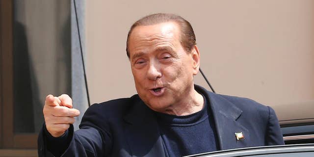 FILE - In this Friday, May 9, 2014 file photo, Silvio Berlusconi smiles as he leaves the "Sacra Famiglia" foundation in Cesano Boscone, near Milan, Italy. An Italian appeals court says former Premier Silvio Berlusconi could not be found guilty of paying for sex with a Moroccan teen because he appears to have been unaware of her age. The court on Thursday, Oct. 16, 2014 issued its lengthy reasoning behind its July decision to overturn a conviction against Berlusconi for paying for sex with a 17-year-old Moroccan, Karima el-Mahroug, then using his influence to cover it up. Both he and Mahroug denied ever having sex. (AP Photo/Antonio Calanni, Files)