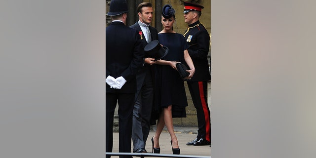 British soccer player David Beckham and his wife Victoria arrive at Westminster Abbey before the wedding of Britain's Prince William and Kate Middleton, in central London April 29, 2011.