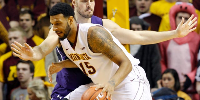 Minnesota forward Maurice Walker (15) drives against Northwestern forward Nikola Cerina during the first half of an NCAA college basketball game in Minneapolis, Saturday, Feb. 1, 2014. (AP Photo/Ann Heisenfelt)