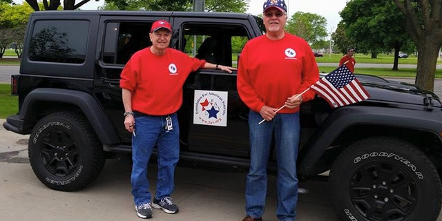 Foundation for American Veterans' Bob McDonald poses with flag (right)