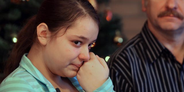 Dec. 22, 2012: Kristina Shevchenko, Clackamas Town Center shooting victim, talks to reporters for first time at her house as her father Veniamin looks on.