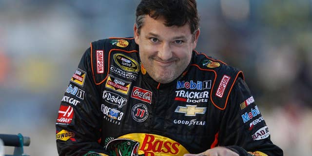 Tony Stewart looks to the crowd during driver introductions prior to the start of the NASCAR Sprint Cup race at Richmond International Raceway in Richmond, Va., Saturday, Sept. 6, 2014. (AP Photo/Steve Helber)