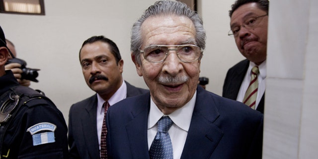 FILE - In this Jan. 24, 2013 file photo, Guatemala's former dictator Efrain Rios Montt (1982-1983) leaves the courtroom after his pre-trial hearing in Guatemala City. With his trial set to start Tuesday, March 19, 2013, prosecutors hope to painstakingly prove through a detailed recreation of the military chain of command that Rios Montt must have had knowledge of the massacres of Mayan Indians and others in the Guatemalan highlands. Because he held absolute power over the U.S.-backed military government, his failure to stop the slaughter is proof of his guilt, prosecutors and lawyers for victims say. (AP Photo/Moises Castillo, File)