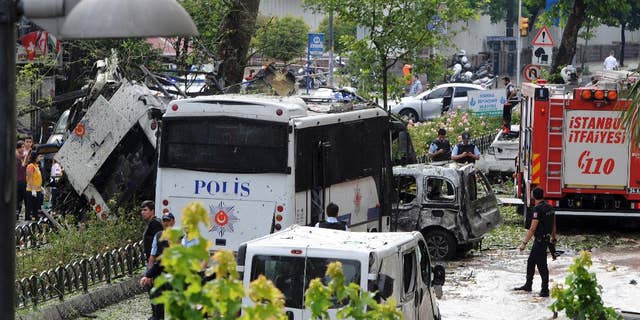 Turkish security officials and firefighters at the site of a bus explosion Tuesday.
