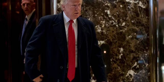 President-elect Donald Trump comes to the lobby to speak to members of the media at Trump Tower in New York, Dec. 6, 2016.