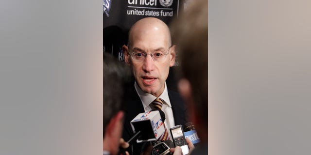 Adam Silver, the new NBA Commissioner, talks with reporters during the half time of an NBA basketball game between the Sacramento Kings and the Toronto Raptors in Sacramento, Calif., Wednesday, Feb. 5, 2014. Silver replaced David Stern Feb. 1, who retired after 30 years as the head of the NBA.(AP Photo/Rich Pedroncelli)