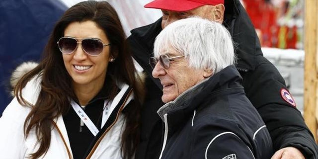 Fabiana Flosi (L) and Bernie Ecclestone (R), pose with Formula One champion Niki Lauda (rear)