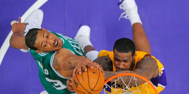 In this Feb. 20, 2013, file photo, Boston Celtics center Fab Melo, left, of Brazil, and Los Angeles Lakers forward Earl Clark go up for a rebound during an NBA basketball game in Los Angeles