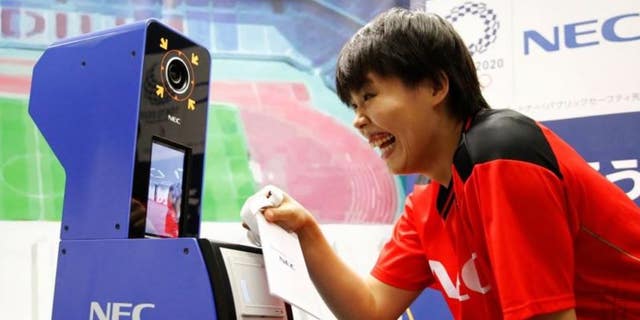 NEC Red Rockets' volleyball player Haruyo Shimamura demonstrates the face recognition system for Tokyo 2020 Olympics and Paralympics, which is developed by NEC corp, in Tokyo, Japan, August 7, 2018.