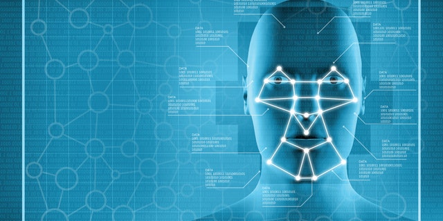 Facial recognition system showing a blue interface with a human head and biometrics data, with a grid of relevant points connected to facial features: used for survellaince, privacy control and identity tracking (Big Brother).