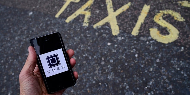 File photo: A photo illustration shows the Uber app logo displayed on a mobile telephone, as it is held up for a posed photograph in central London, Britain October 28, 2016. (REUTERS/Toby Melville)