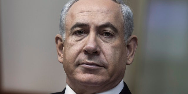 Israeli Prime Minister Benjamin Netanyahu chairs the weekly cabinet meeting in his Jerusalem offices, Sunday, Feb. 3, 2013. Israel's president formally asked Prime Minister Benjamin Netanyahu on Saturday Feb. 2, 2013 to form the next government, and Netanyahu pledged that his new administration will be committed to advancing peace talks with the Palestinians.(AP Photo/Oliver Weiken, Pool)