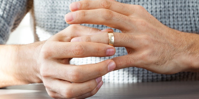 Man taking off wedding ring
