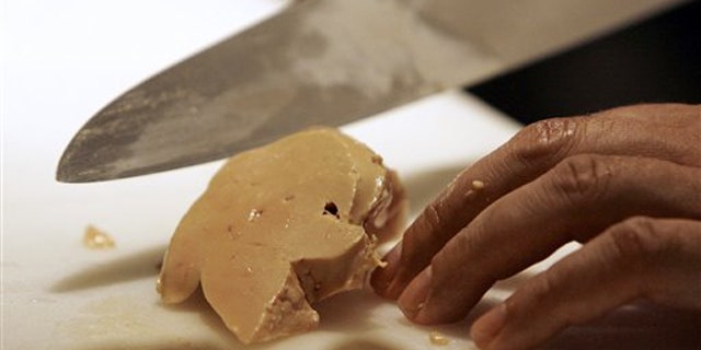 Todd Stein, the executive chef at MK in Chicago, slices a piece of foie gras.